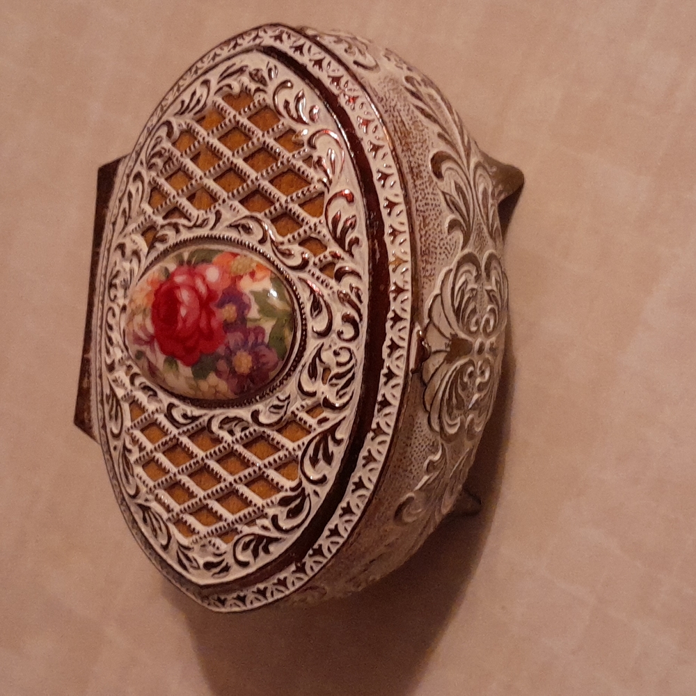 Antique metal jewelry box lined with velvet interior